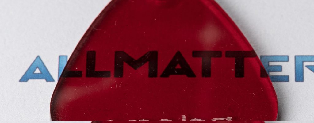 Czerwony element z logo ALLMATTER na jasnym tle